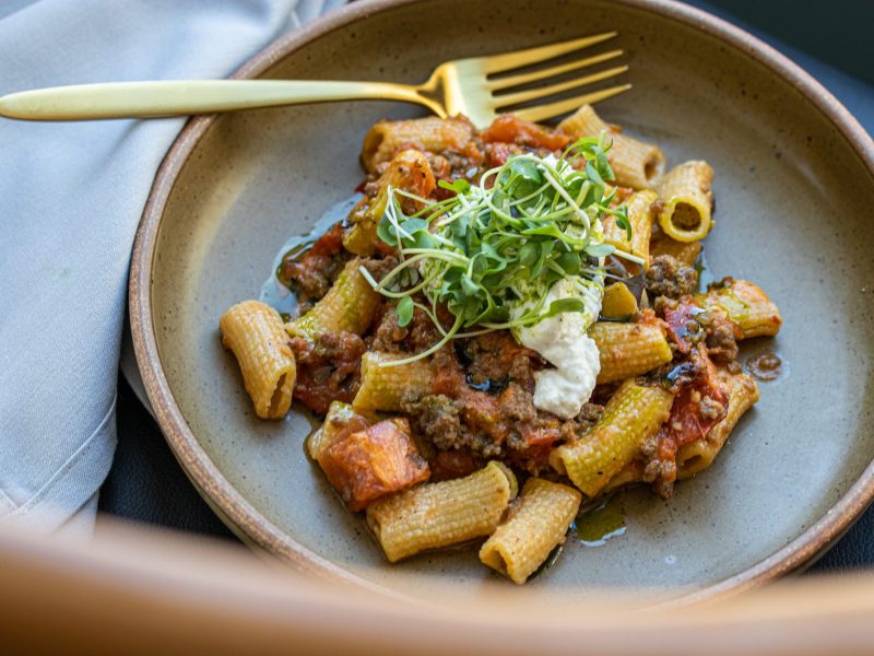 House-made rigatoni with crushed tomato sauce, spiced duck sausage, and ricotta at Ellie Bird in Falls Church, Virginia