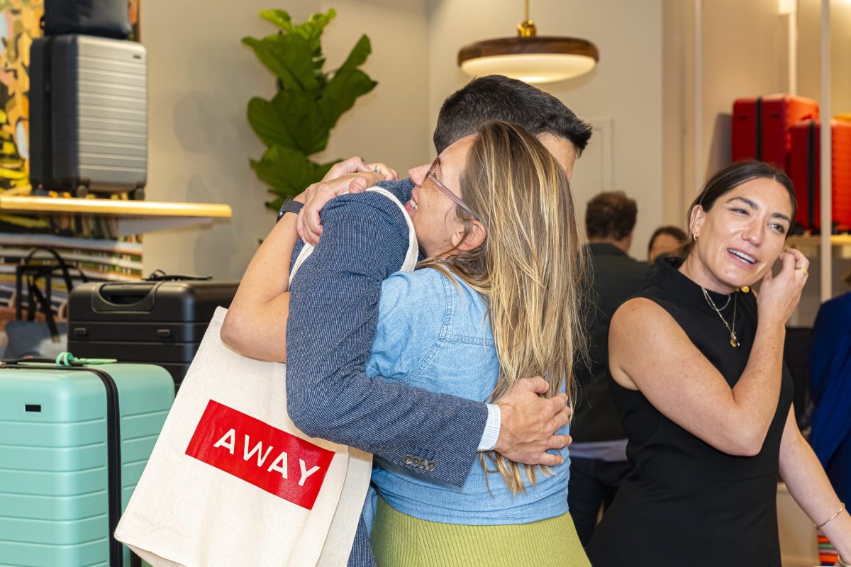 People embrace at a party for the Away and Kevin Tien collaboration