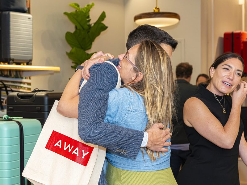 People embrace at a party for the Away and Kevin Tien collaboration