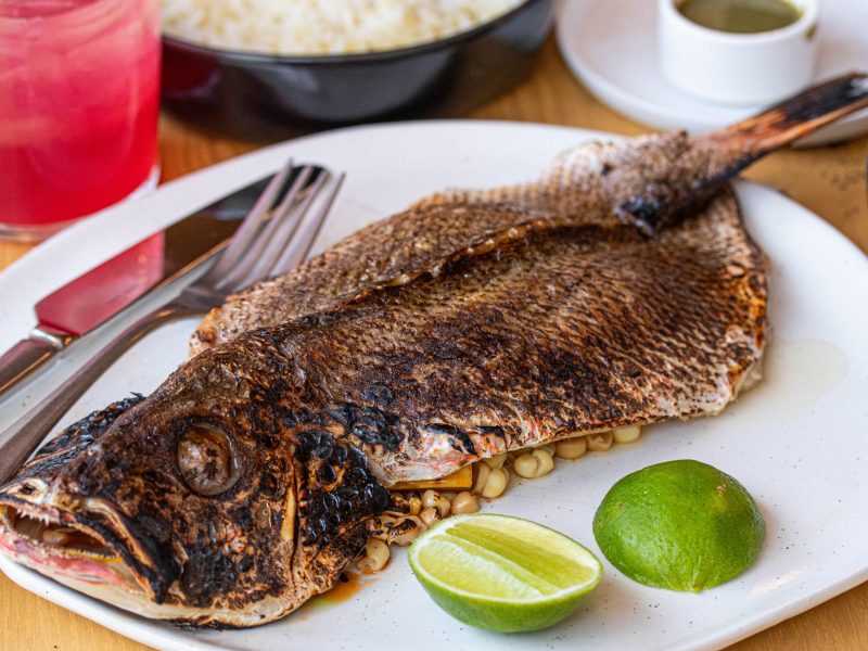 A whole butterflied snapper on a plate.