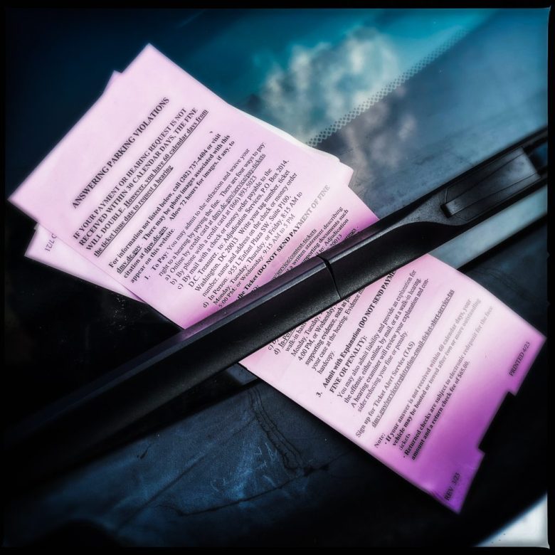 A parking ticket stuck under a windshield wiper in Washington D.C.