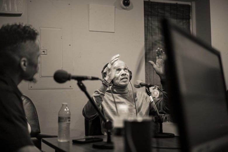 Charles Hopkins records an episode of a podcast.
