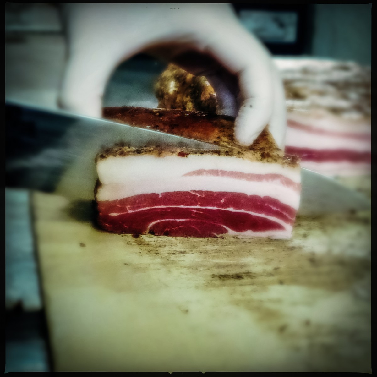 Cook slicing bacon